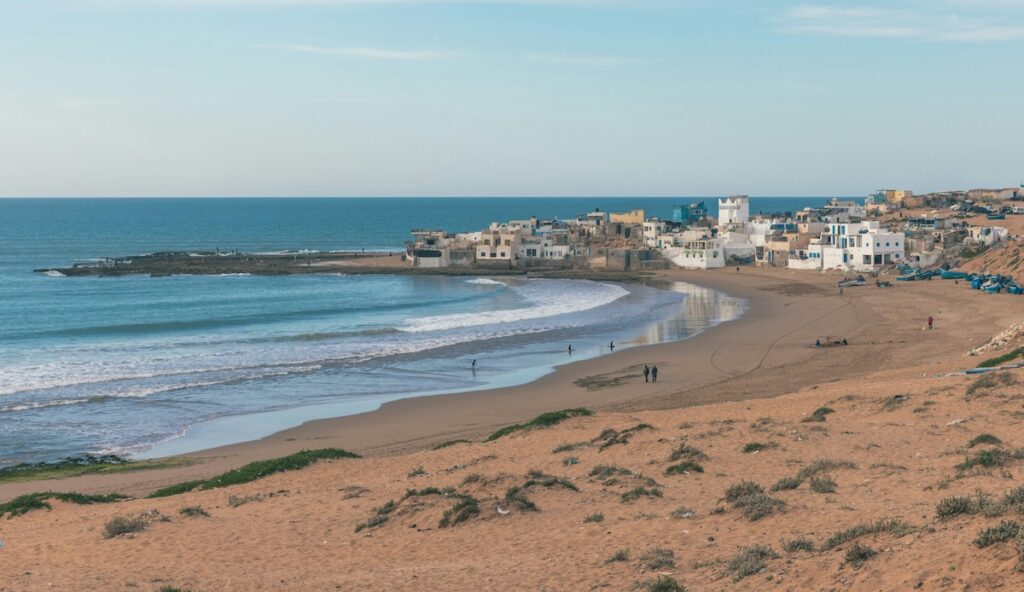 Waves breaking in front of a Moroccan surf town